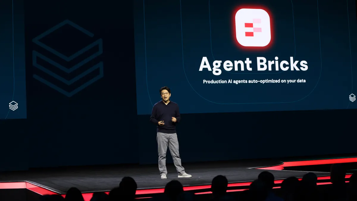 Hanlin Tang, CTO of neural networks at Databricks, speaks on stage at the data an ai platform company's annual conference.