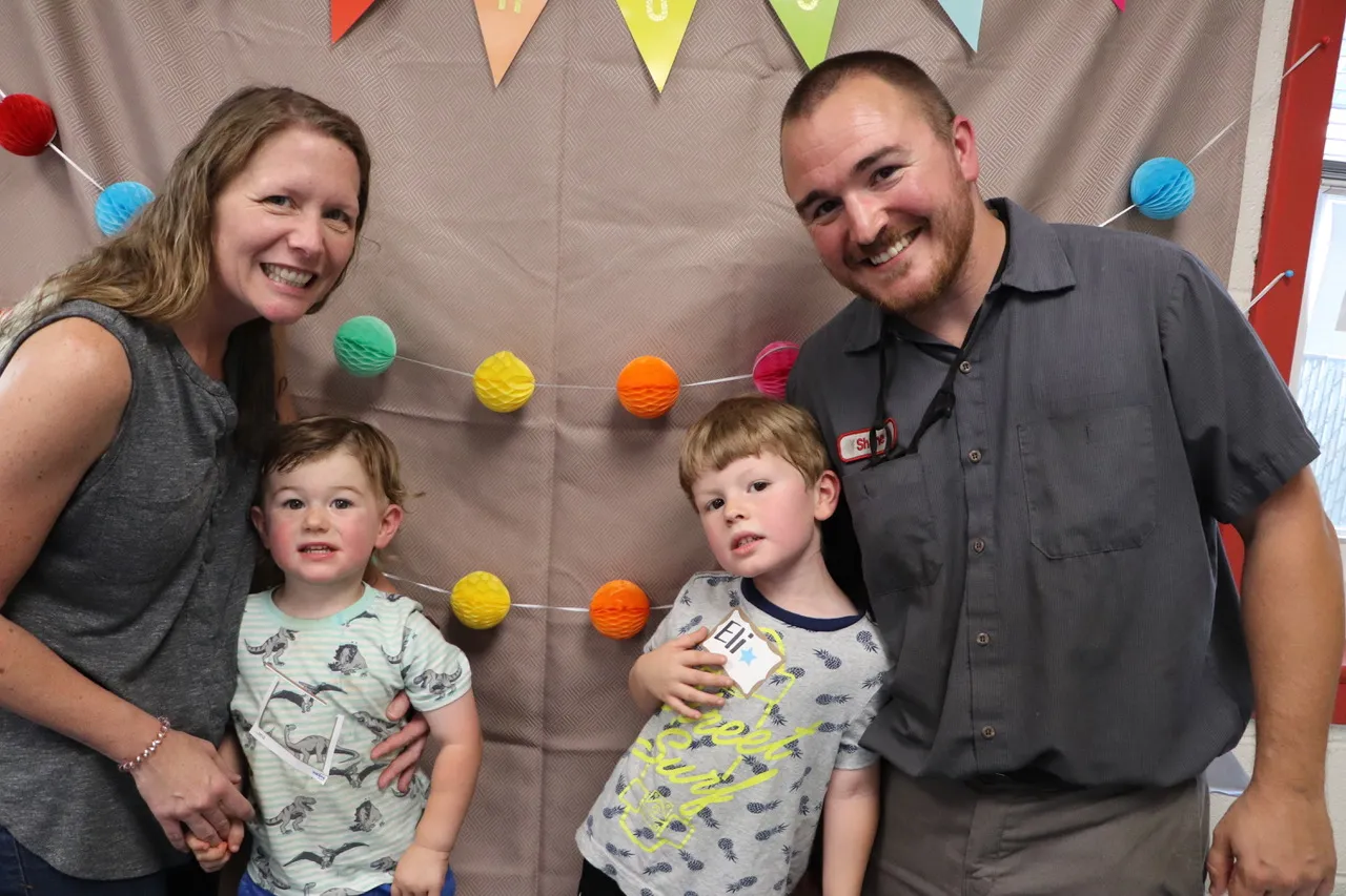 Shane Robertson poses with family, including his two sons, at the Little Lions Learning Lab.