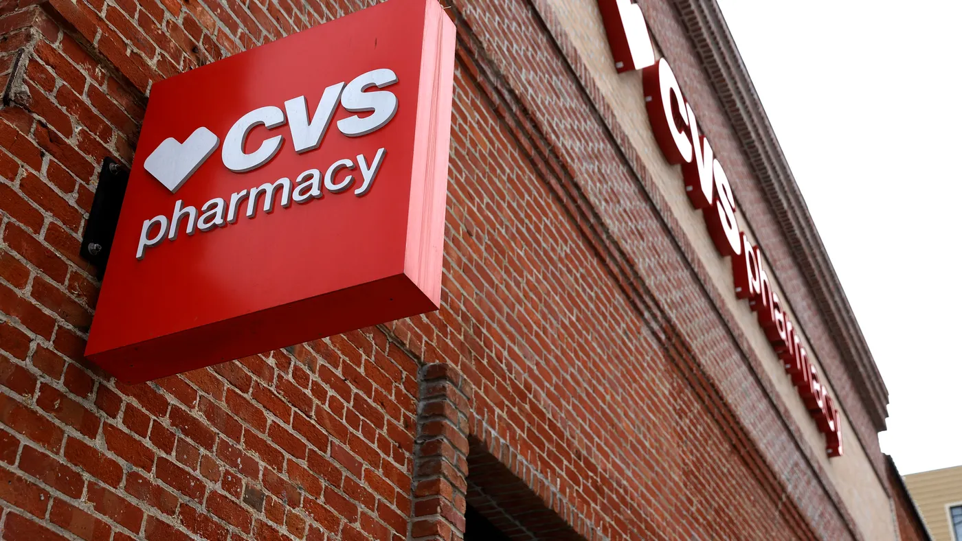 A brick wall with a red CVS Pharmacy sign.