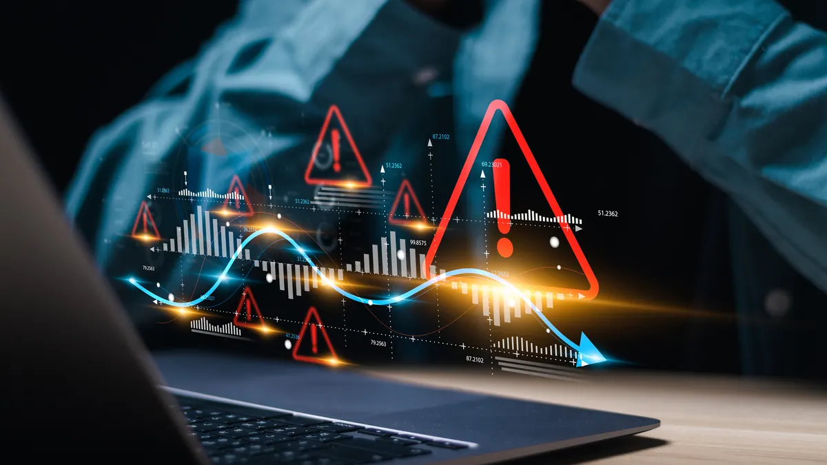 Businessman use laptop with virtual world economic growth chart with red warning sign