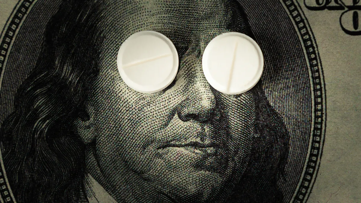 pills lie instead of eyes on a one hundred dollar bill in close-up.