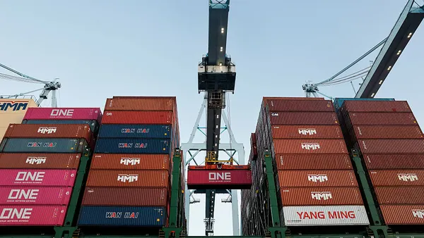 A shipping container is loaded onto a container ship.