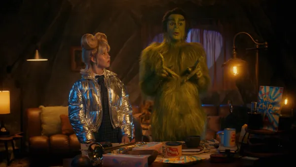 Actor Walton Goggins (right) appears as the Grinch alongside Mindy Lou Who in new holiday ads from Walmart.