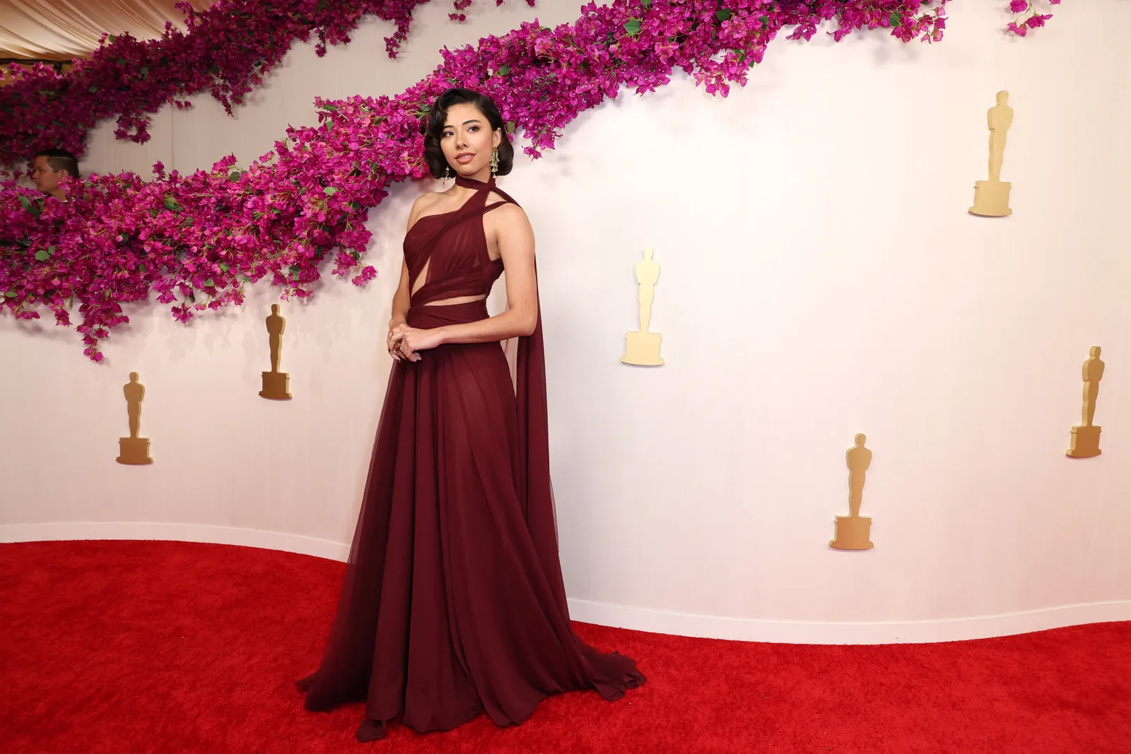 Xochitl Gomez wears a dark red gown.