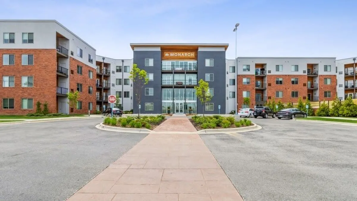 Brick and silver, four-story apartment building