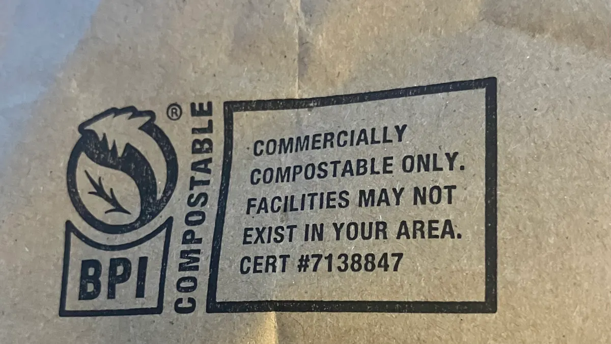 A brown bag bears a BPI compostable logo and says 'COMMERCIALLY COMPOSTABLE ONLY, FACILITIES MAY NOT EXIST IN YOUR AREA'
