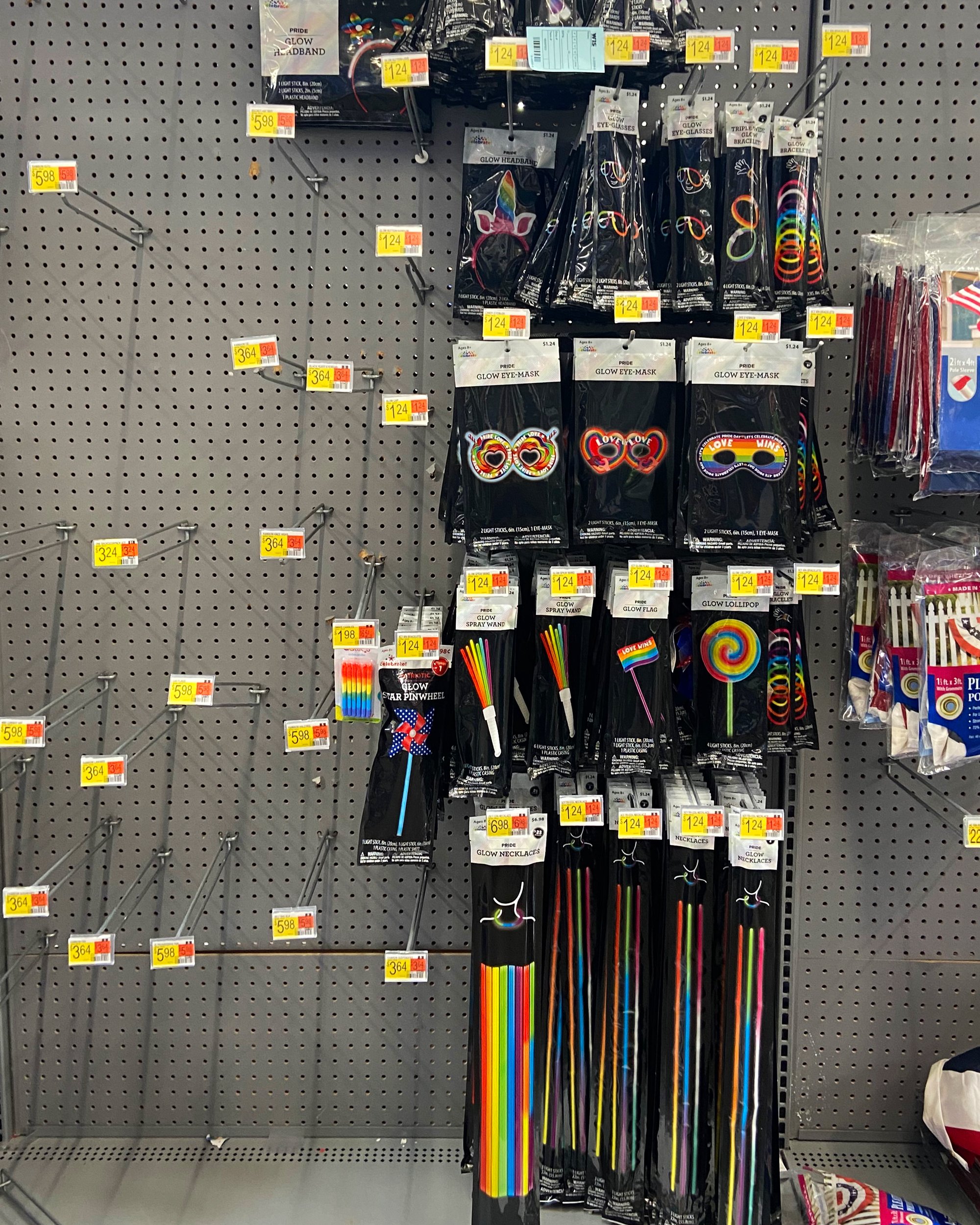 A store display of items like glow sticks, with several empty hooks.