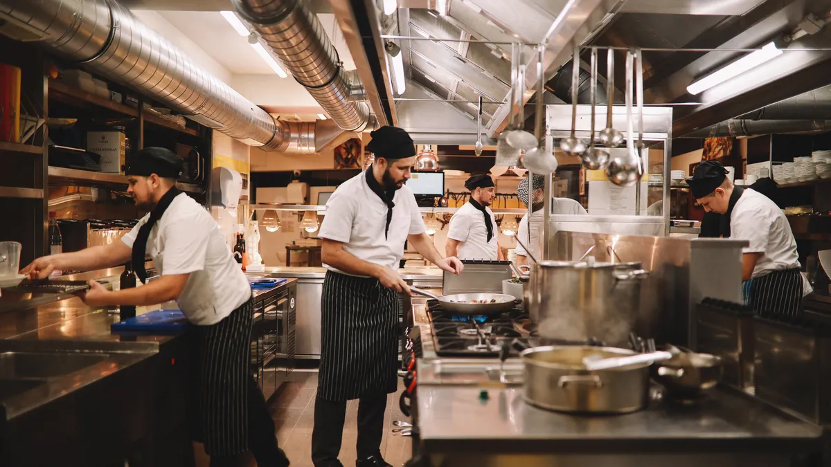 5 chefs work in a restaurant kitchens