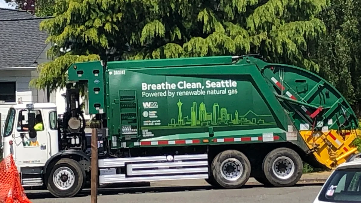 A WM truck with branding on its side that reads, "Breathe clean, Seattle; Powered by renewable natural gas."