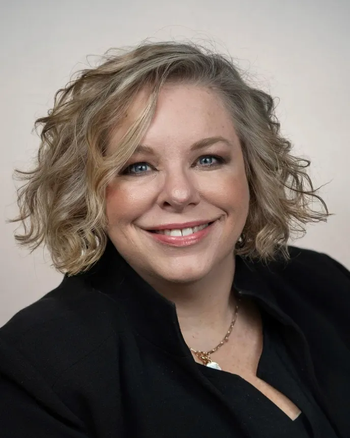 Headshot of a woman in professional attire.