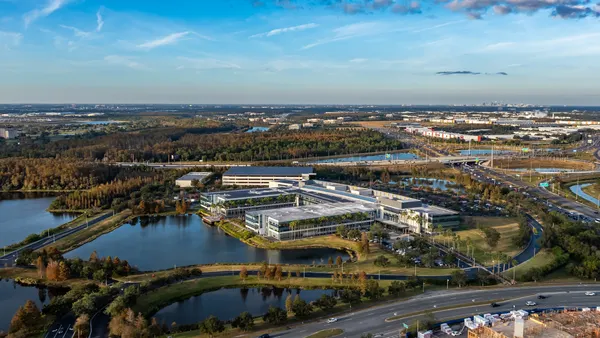 A corporate headquarters in a flat landscape dotted with lakes.