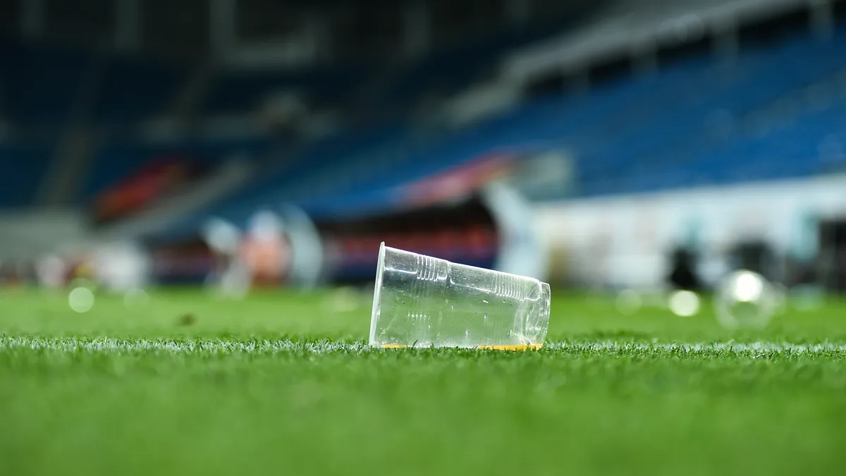 Plastic cup on green turf field