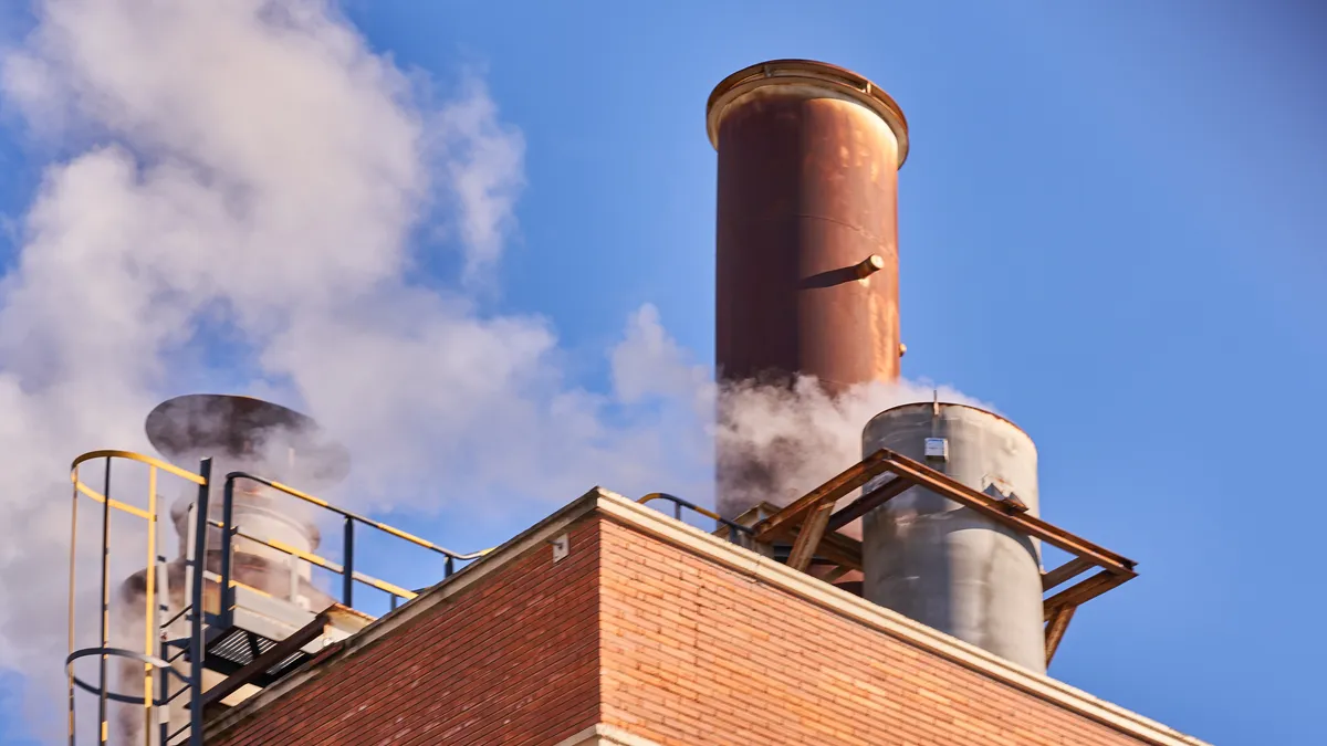 An industrial chimney releasing fumes, steam and polluting gases.