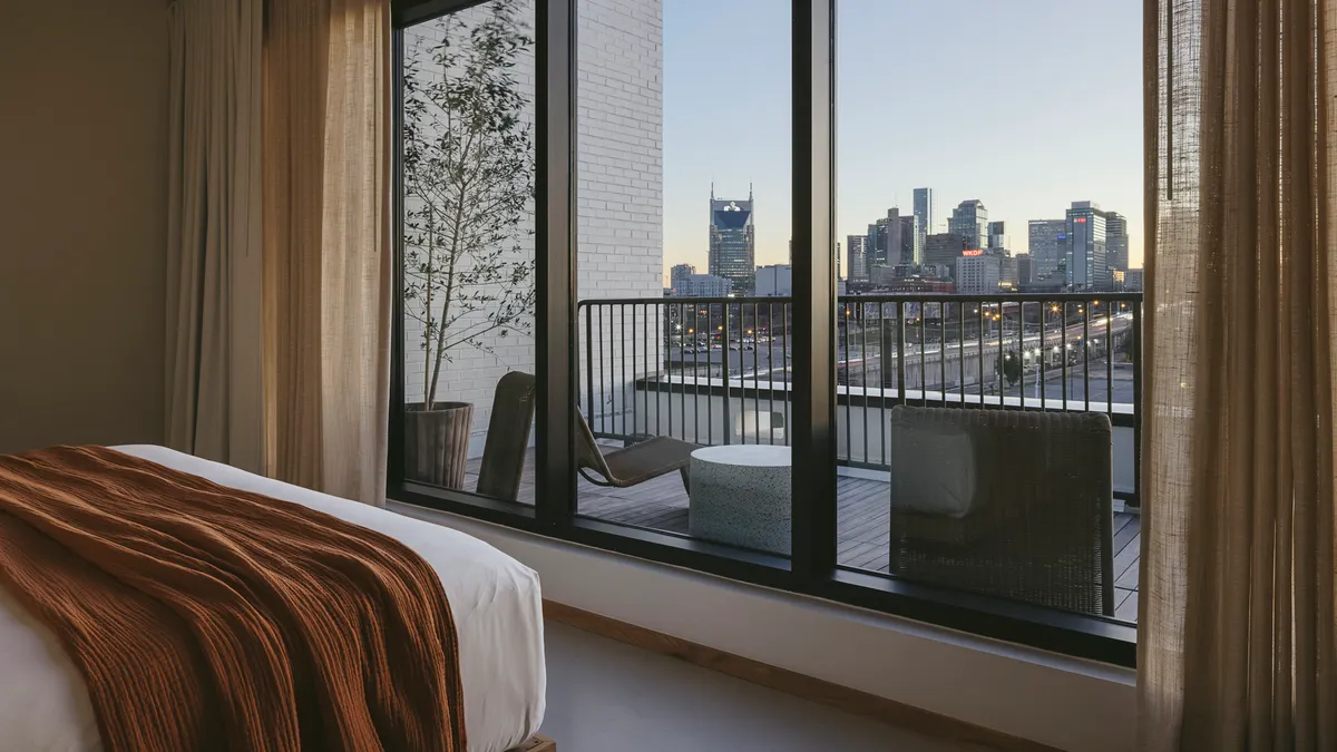 The Nashville skyline can be seen from a hotel room window.