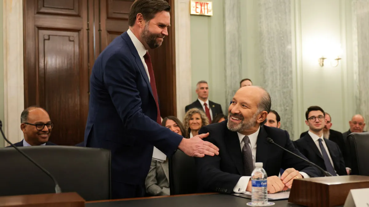 Vice President J.D. Vance pats Commerce Secretary nominee Howard Lutnick on the shoulder.