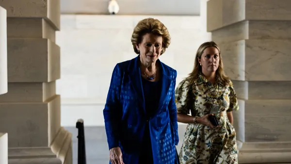 U.S. Sen. Debbie Stabenow is seen walking alongside a woman