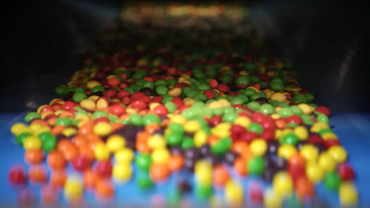 A pile of brightly colored Skittles candies