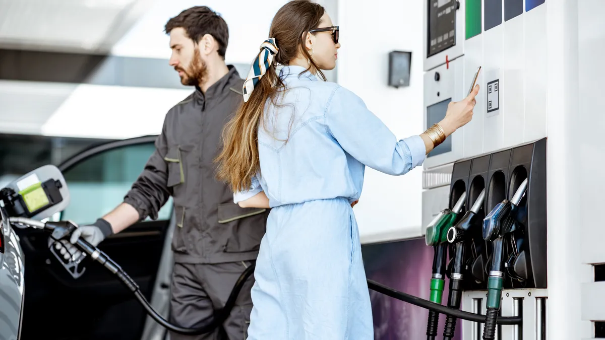 People standing to refill gas