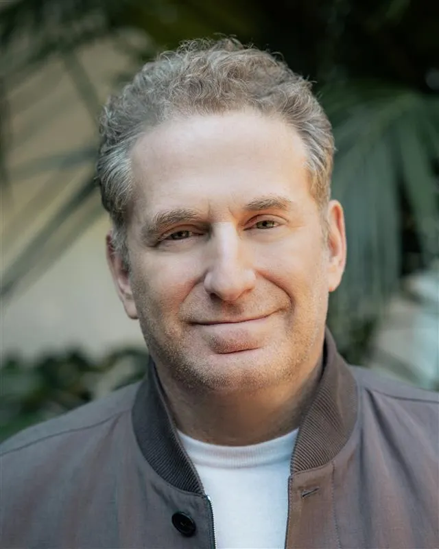 Headshot of a man in professional attire.