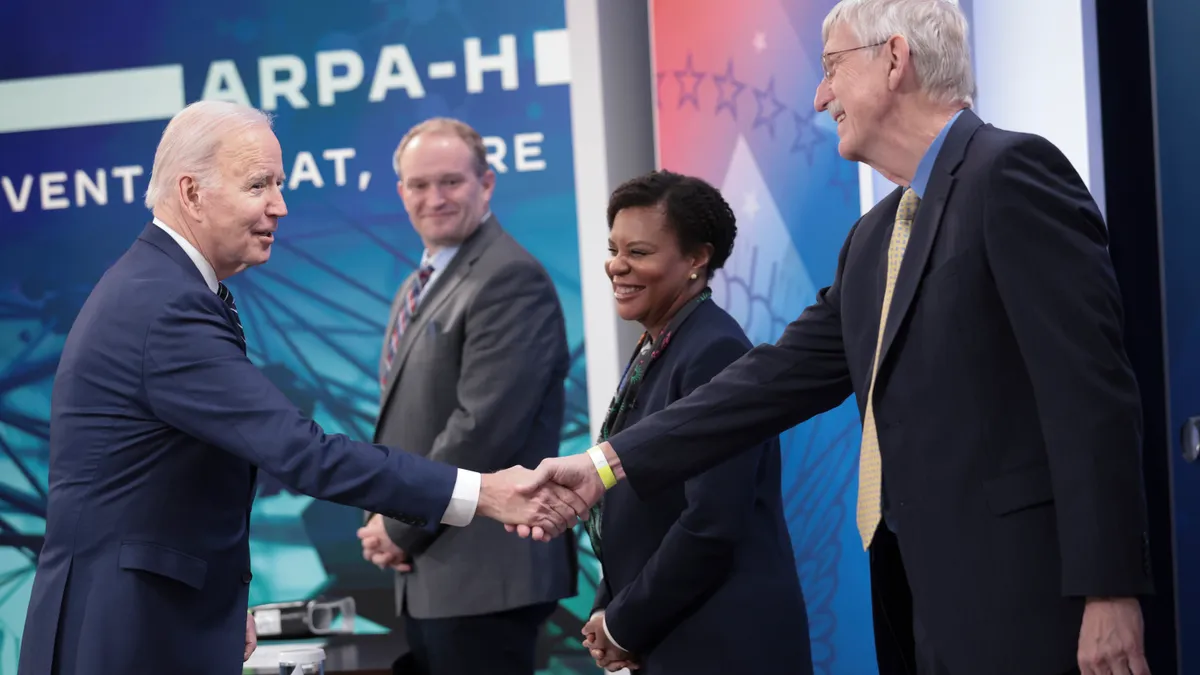 A picture of President Joe Biden greeting panel participants at a White House event.