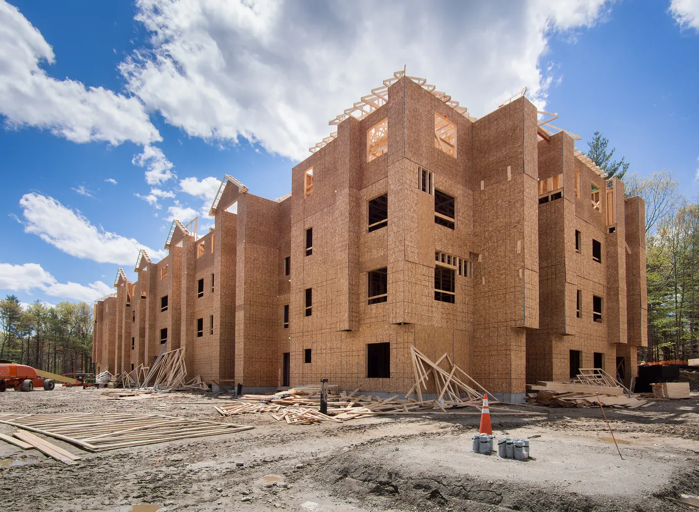 Wood-framed apartment building under construction.