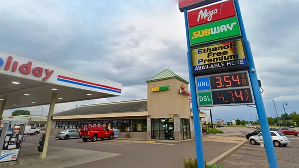 a screenshot of the exterior of a convenience store. A sign near the road says "Mega" while a sign on the store itself says "Subway."