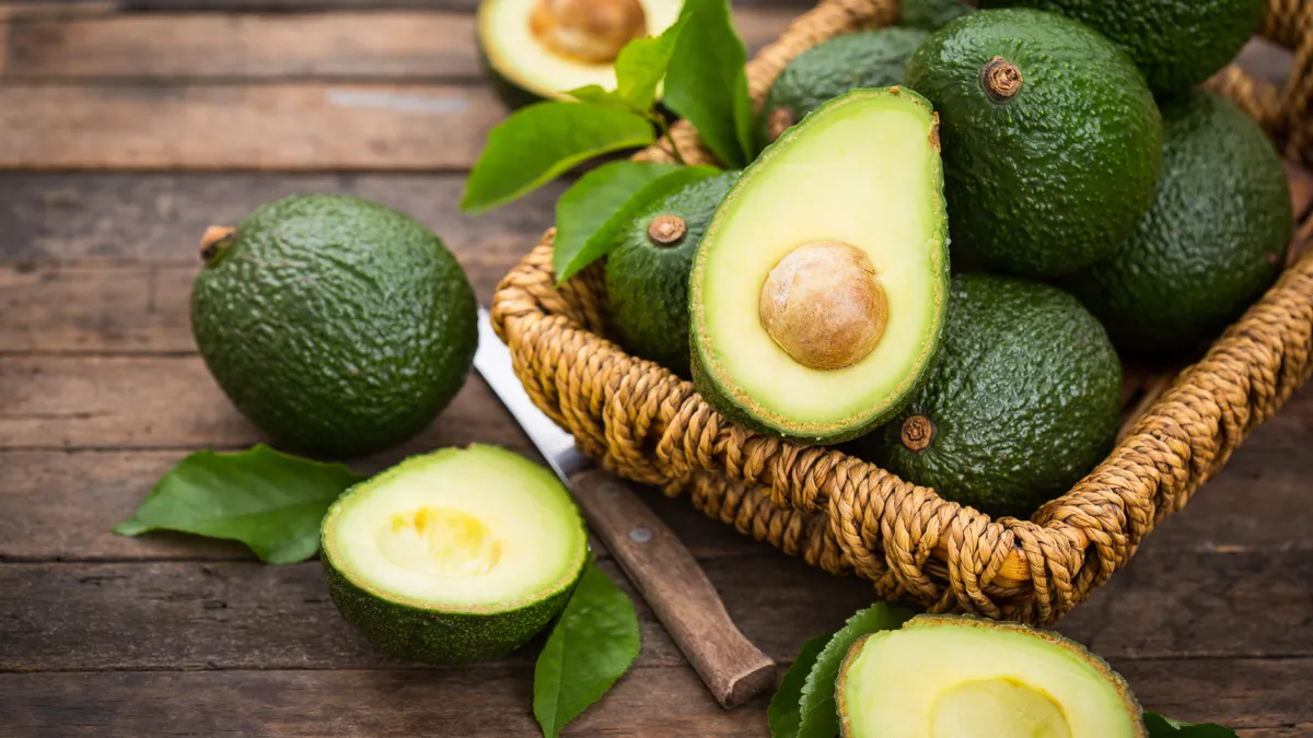 Fresh organic avocado on the wooden table