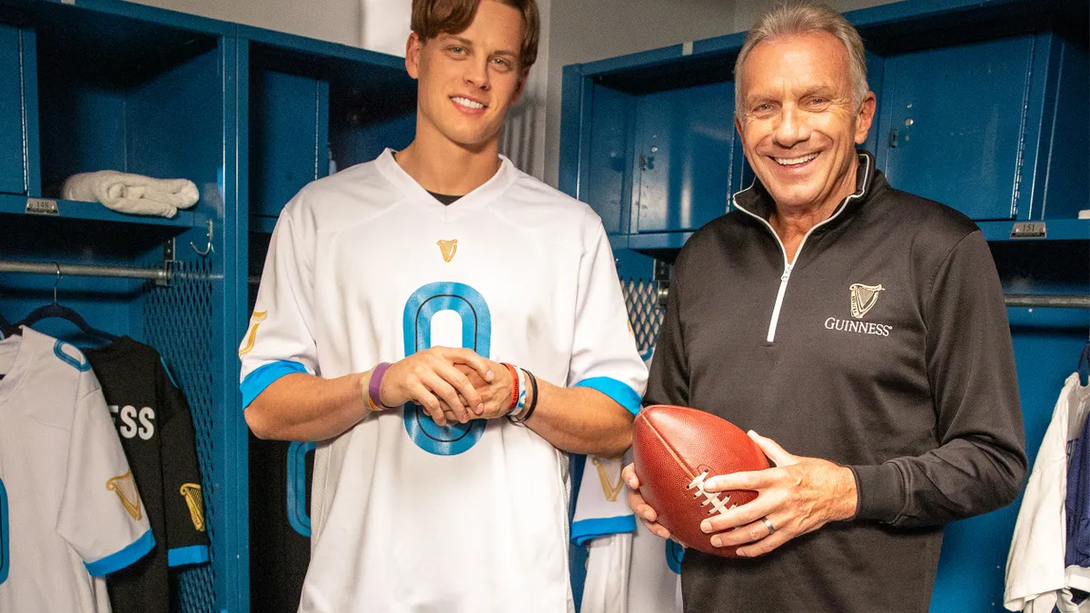 NFL stars Joe Burrow (left) and Joe Montana (right) stand side-by-side in a locker room as part of a Guinness campaign.