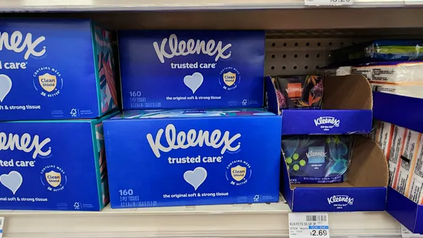 Blue boxes of Kleenex tissue on a store shelf.