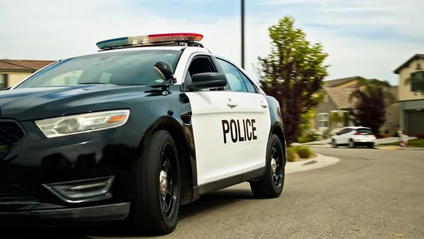 A police car parked on a suburban street.