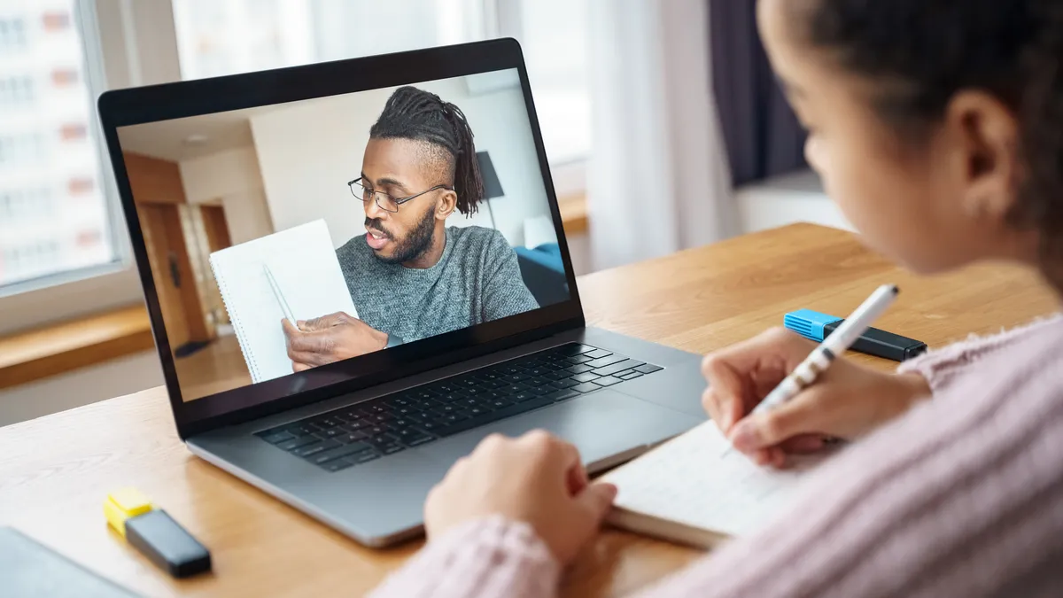 Teacher instructs student in remote learning.