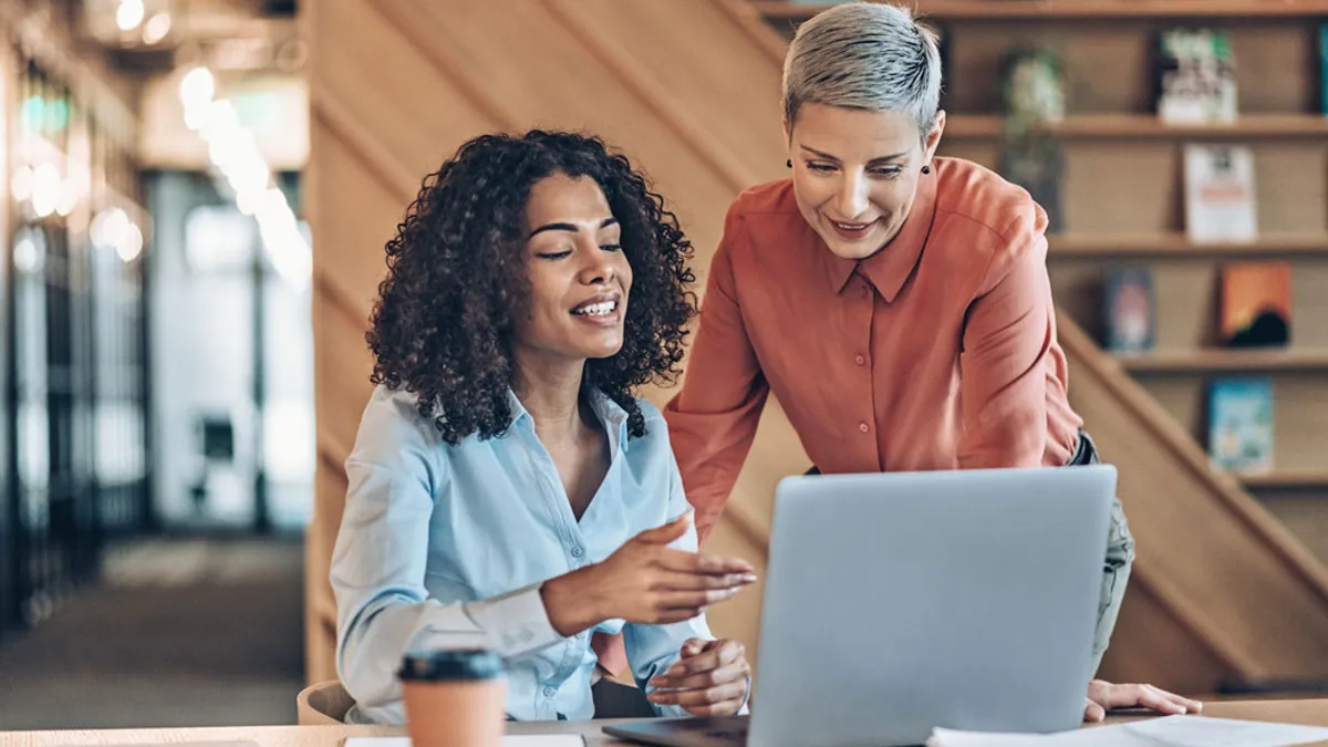 two people looking at laptop