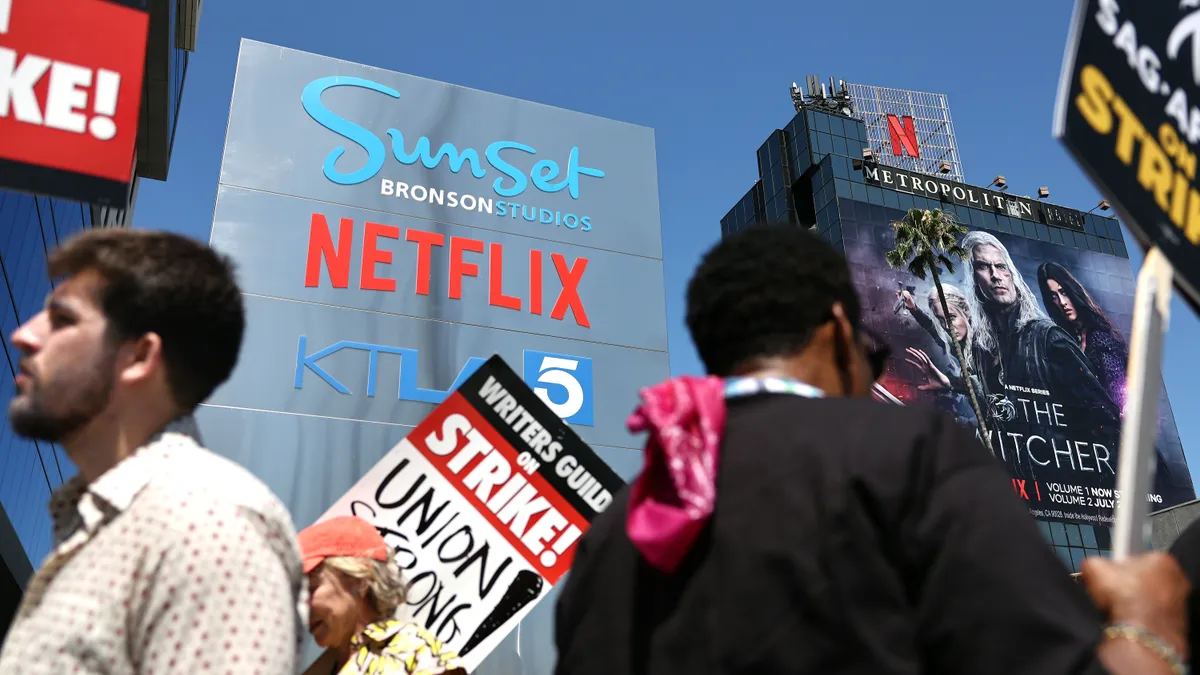 Workers hold picket signs outside of Netflix offices.