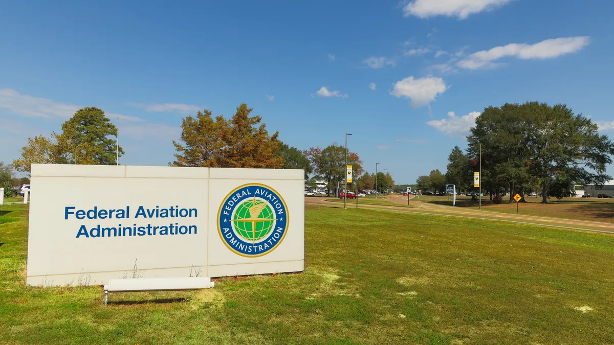 Federal Aviation Administration sign and logo on a field outside its offices