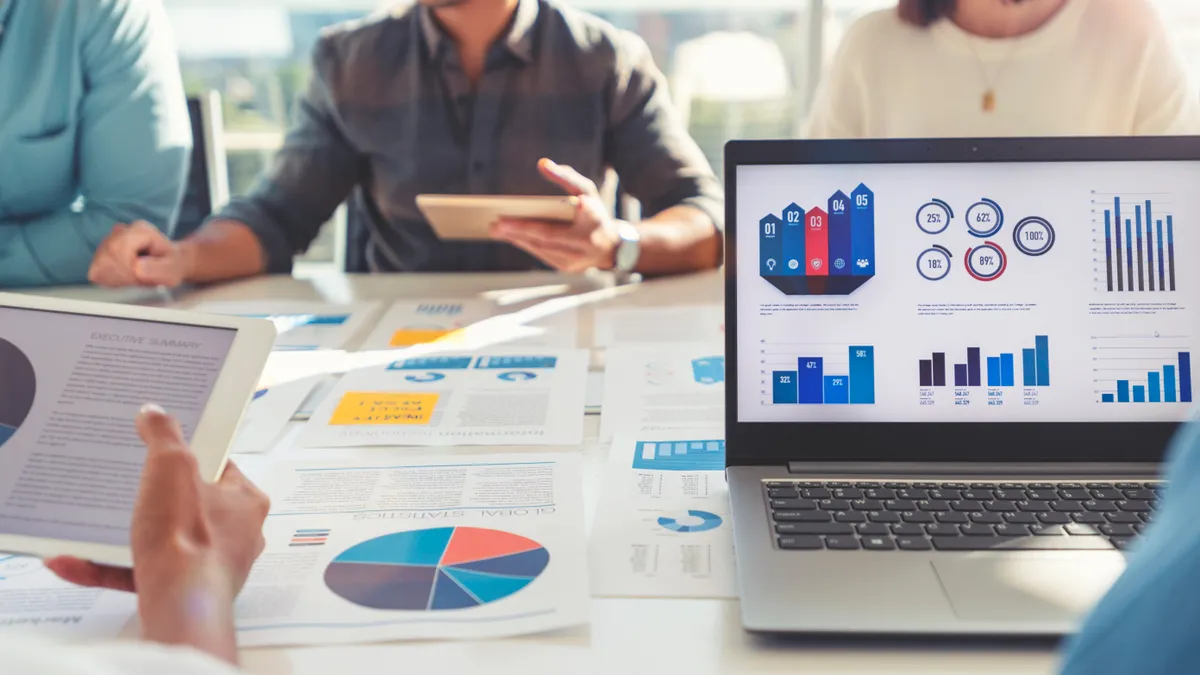 A group of people look at and discuss financial indicators