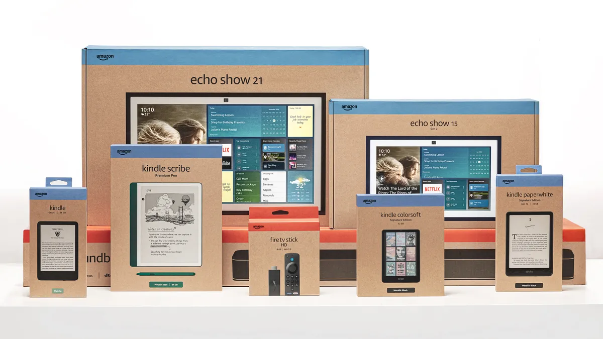 An array of Amazon Kindle, Echo and Fire TV devices in brown paper boxes with company branding.