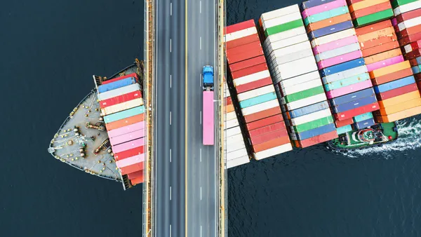 Container ship passing under a bridge