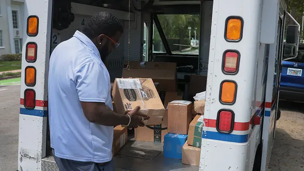 Postal carrier Marc Jacques delivers the mail in a neighborhood on March 19, 2026 in Miami, Florida.