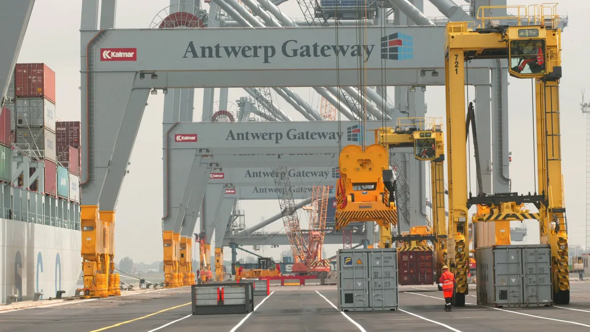 Cranes unload a container ship at the Antwerp port during the inauguration of the Deurganckdok July 6, 2005 in Antwerp, Belgium.