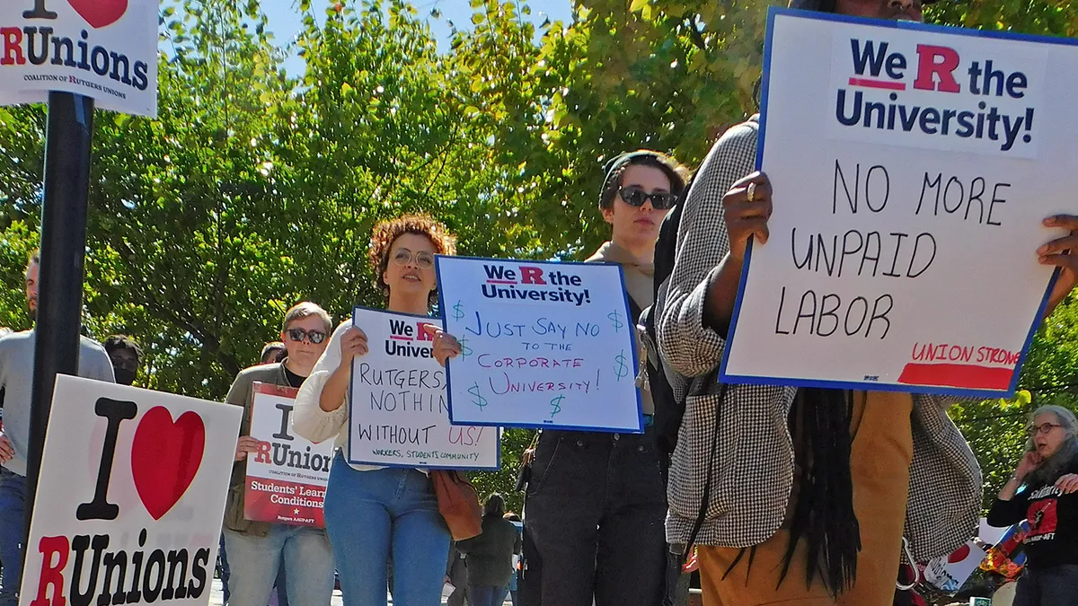 People carry signs that read "We heart R Unions."