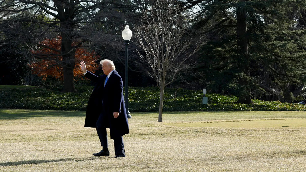 President Donald Trump walks across the White House lawn.