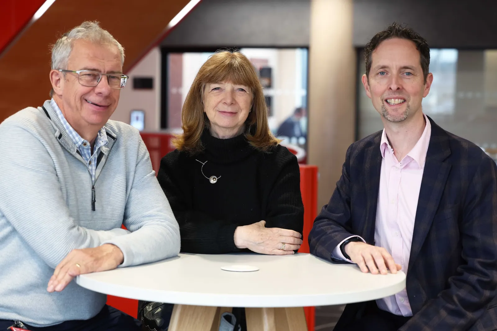 Draig Therapeutics founders John Atack, Ruth McKernan and Simon Ward sit at a table.
