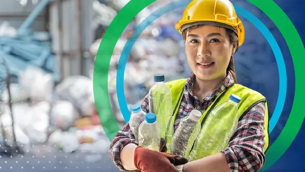 Woman wearing worker hat holding water bottles