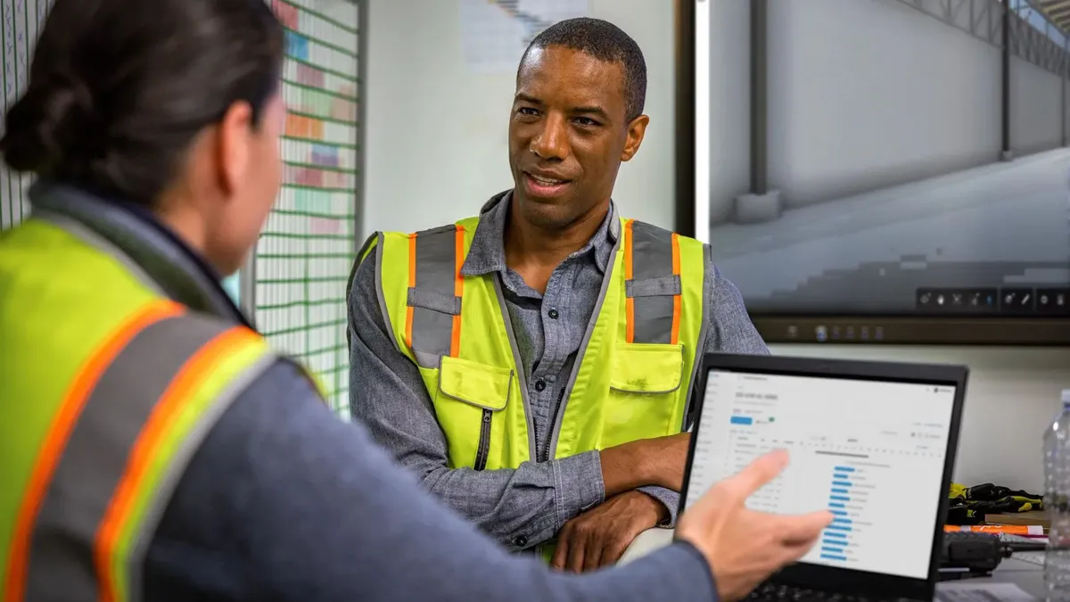 Two construction workers talking