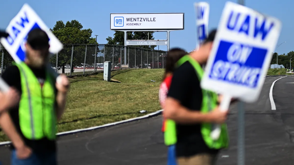 UAW workers hold picket signs outside GM's Missouri plant