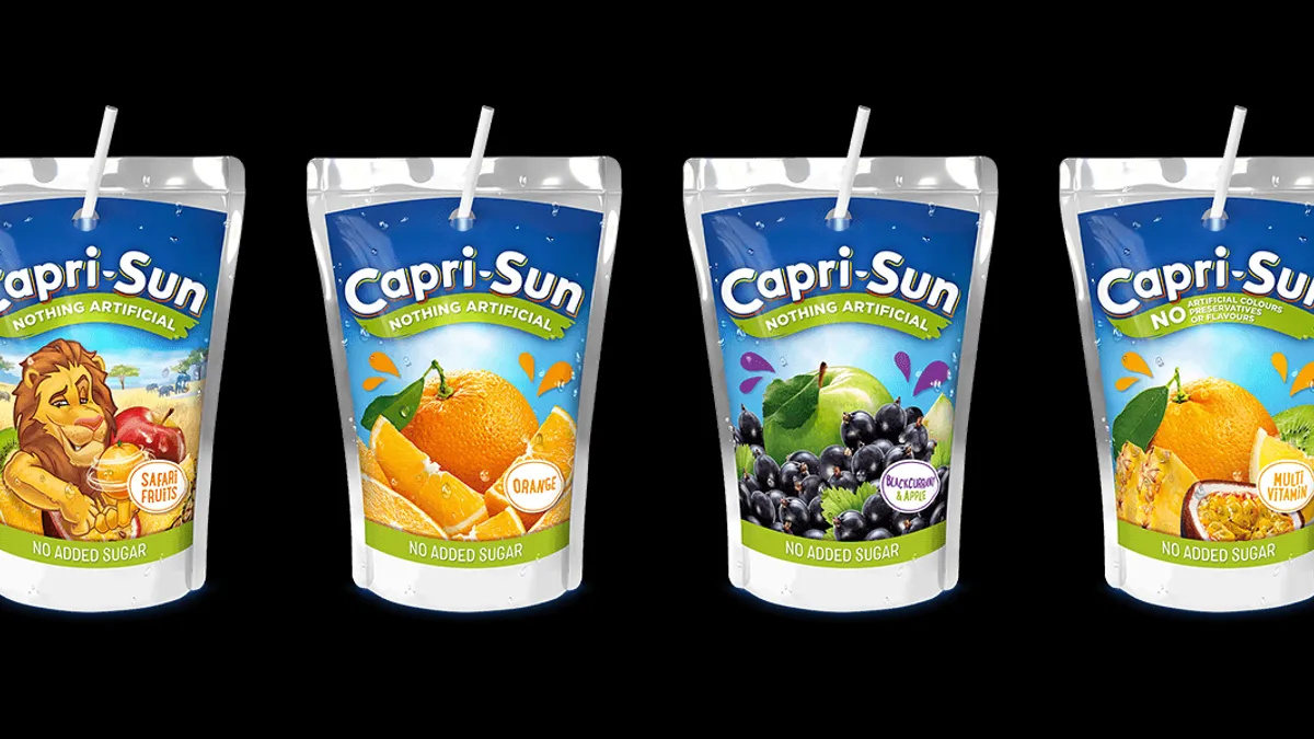 Four pouches of Capri-Sun beverages with straws.