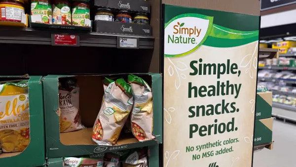 A sign with a sustainability claim inside a grocery store.