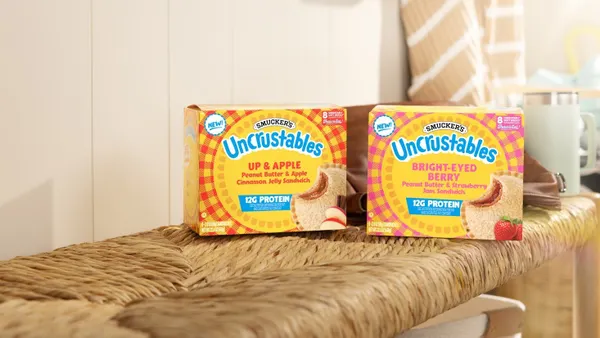 Two boxes of Uncrustables are on a bench.