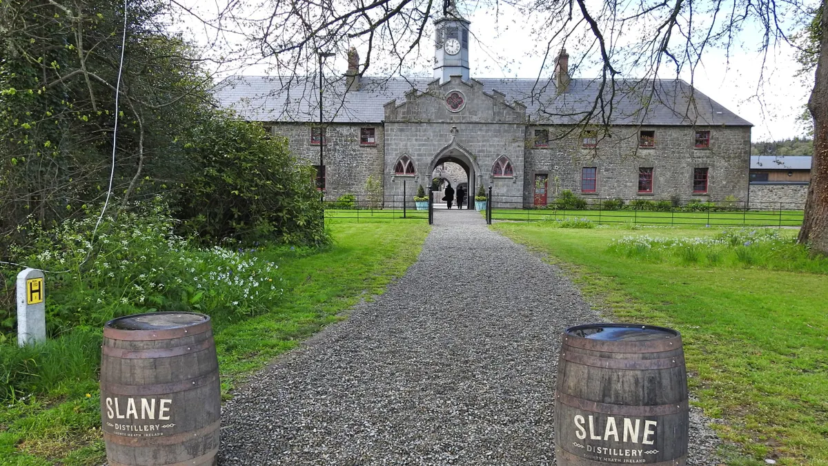 The entry way to the Slane Irish Whiskey Distillery, with barrels on either side.