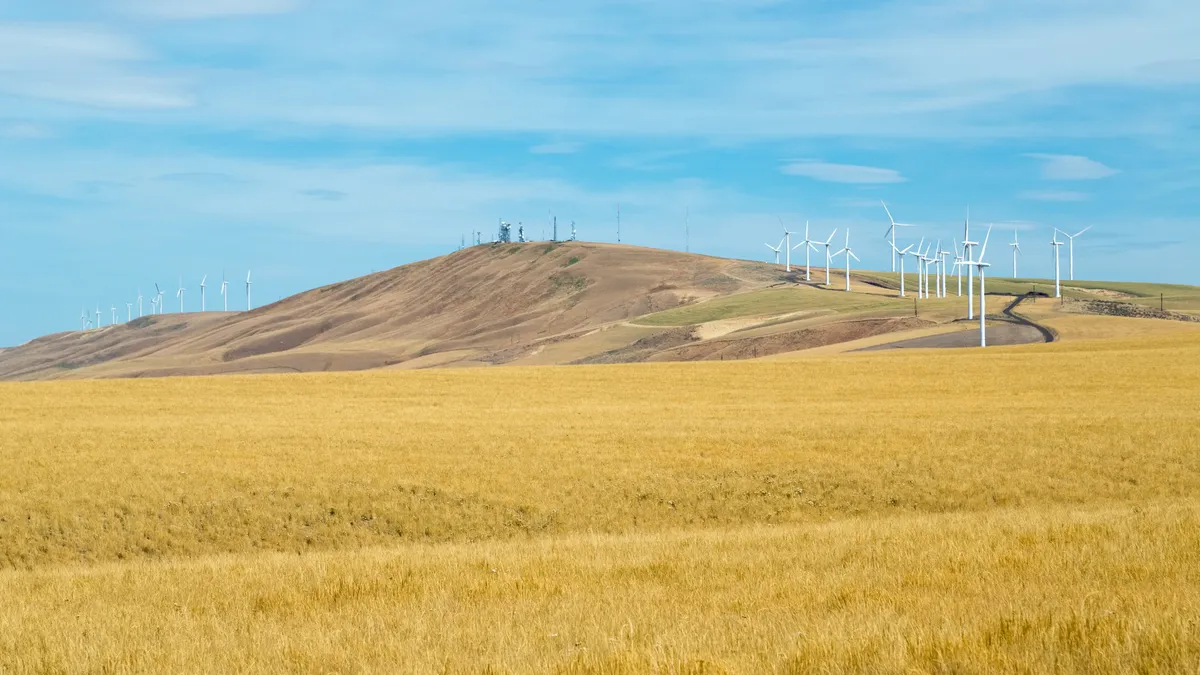 Rolling Hills with Wind Turbines and Telecommunication Towers.